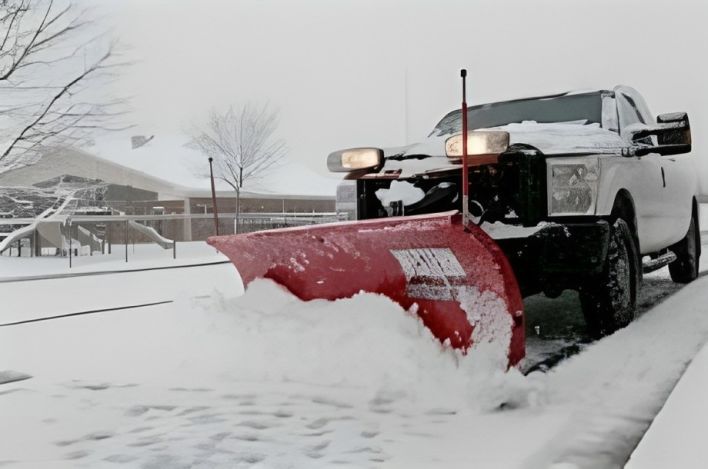 Red Snow Shovel Stuck in Snow